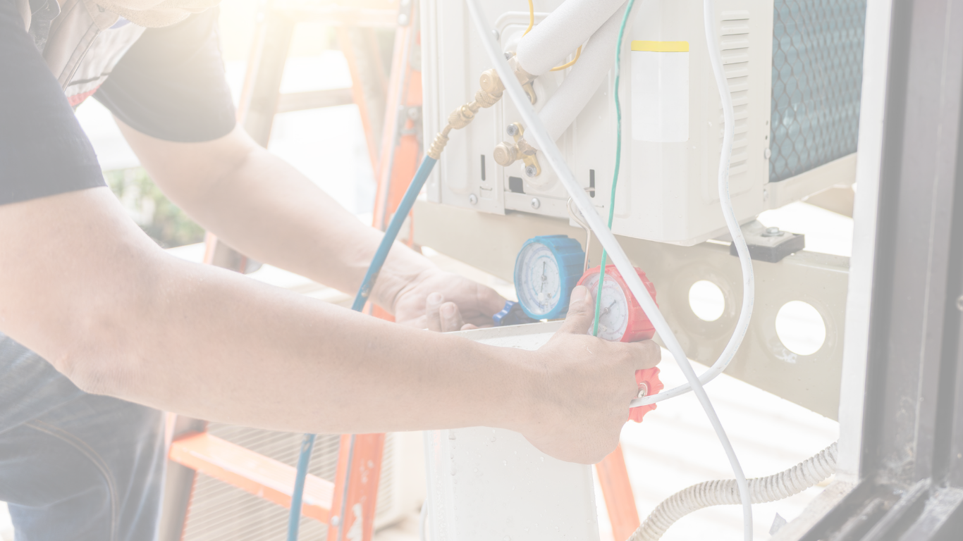 An image of hands working with gauges on an AC system performing an AC tune up in Punta Gorda, Florida